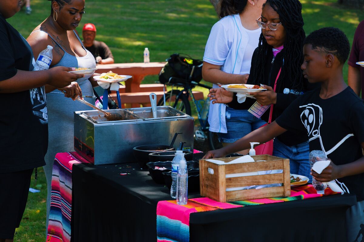 Volunteers and community members sharing a meal at the health fair food station