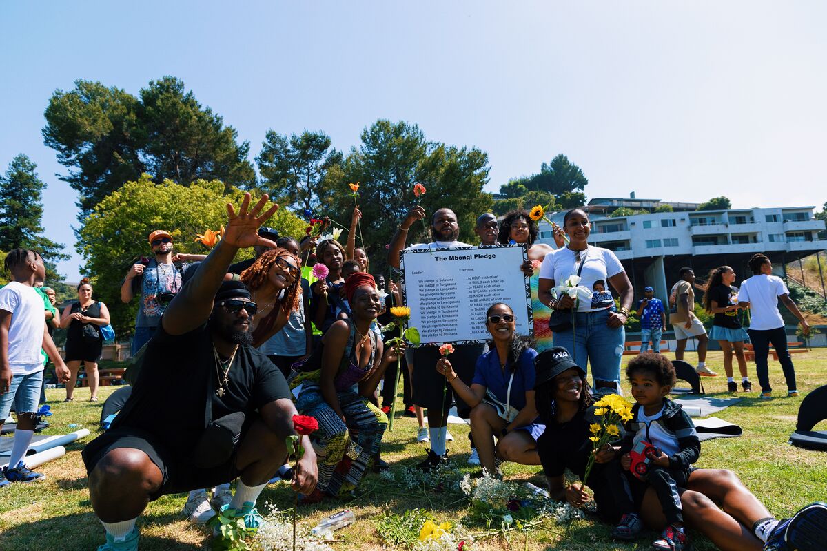 Community members celebrating with flowers during the Mbongi Pledge ceremony