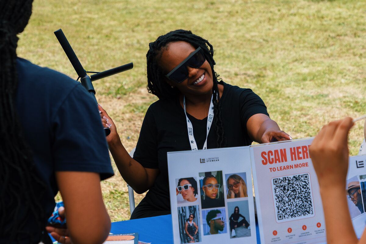 Dermatology education booth with Scan Here QR code for skin health resources